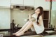 A woman sitting on a kitchen counter eating a bowl of food.