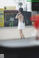 A woman standing in front of a coffee shop.