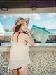 A woman in a straw hat is looking at a map.