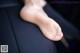 A close up of a person's foot sticking out of a car seat.