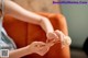 A woman sitting on a couch holding a flower in her hand.