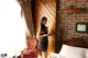 A woman standing in a bedroom next to a bed.