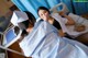 A woman laying in a hospital bed next to a nurse.