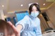 A woman wearing a face mask in a hospital room.