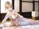 A woman in a kimono laying on a bed.