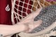 A woman's feet in a hammock with a red curtain.