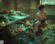 A man sitting on the floor in an abandoned kitchen.