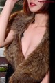 A woman in a fur stole posing for a picture.