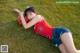 A woman laying on the grass with a basketball.