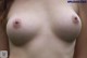 a woman with a big tits is posing for the camera