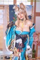 A woman in a blue and gold kimono posing for a picture.